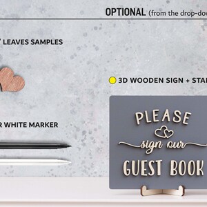May include: A wooden sign with the text "PLEASE sign our GUEST BOOK" in white letters on a grey background. The sign is on a stand and includes two small wooden hearts. The sign is accompanied by a black and white marker and two wooden hearts.