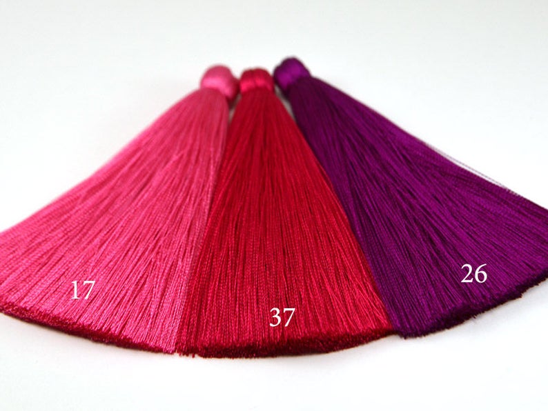 May include: Three silk tassels in shades of pink, red, and purple. The tassels are labeled with the numbers 17, 37, and 26.