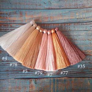 May include: Seven different colors of silk tassel fringe, including white, beige, light brown, pink, peach, gold, and burgundy. The tassels are labeled with numbers: #0, #4, #78, #35, #5, #79, #7, and #77.