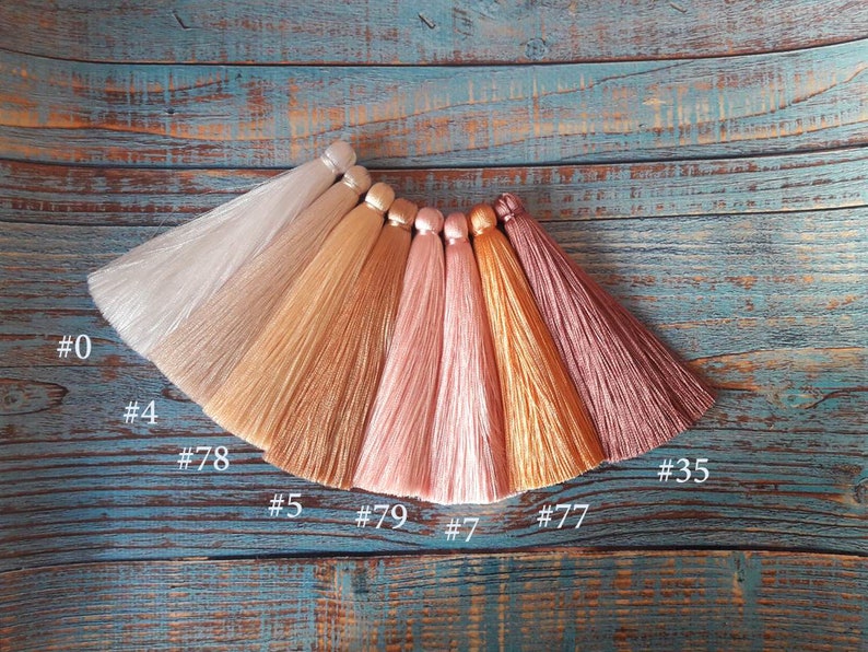 May include: Seven different colors of silk tassel fringe, including white, beige, light brown, pink, peach, gold, and burgundy. The tassels are labeled with numbers: #0, #4, #78, #35, #5, #79, #7, and #77.
