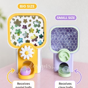 May include: Two plastic vending machines. The larger yellow machine features a flower-patterned front and dispenses pastel balls. The smaller purple machine has a honeycomb-patterned front and dispenses clear balls. Text labels include BIG SIZE, SMALL SIZE, Receives pastel balls, and Receives clear balls.