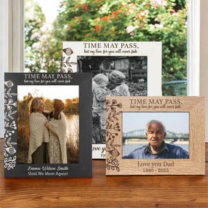May include: Three wooden picture frames with a floral design and the text "Time may pass, but my love for you will never fade". The frames are in different colours: black, white, and brown. The frames are decorated with a floral design and have a space for a photo.