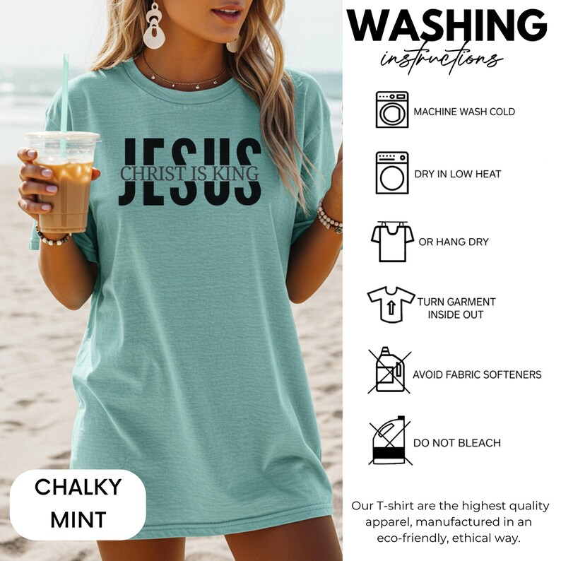 A woman wearing a teal green T-shirt with the text "JESUS Christ is King" printed on it, holding a drink. The image also includes instructions for washing the T-shirt, including machine washing cold, dry in low heat, hanging dry, turning the garment inside out, avoiding fabric softeners, and not bleaching.