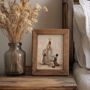 May include: A framed print with a religious theme. The artwork depicts a woman in a white robe with a crown, surrounded by three figures. The frame is made of rustic wood. A vase with dried flowers sits to the left.