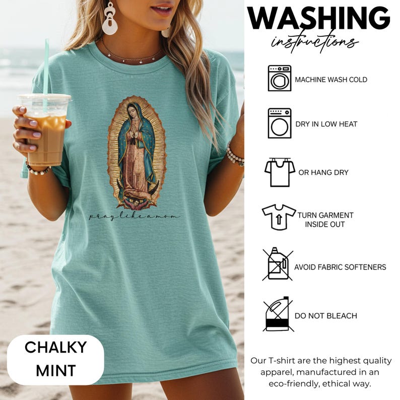 May include: A chalky mint t-shirt with an image of the Virgin Mary and the text "pray like a mom." Washing instructions are shown on the right. The t-shirt is made of high-quality apparel.