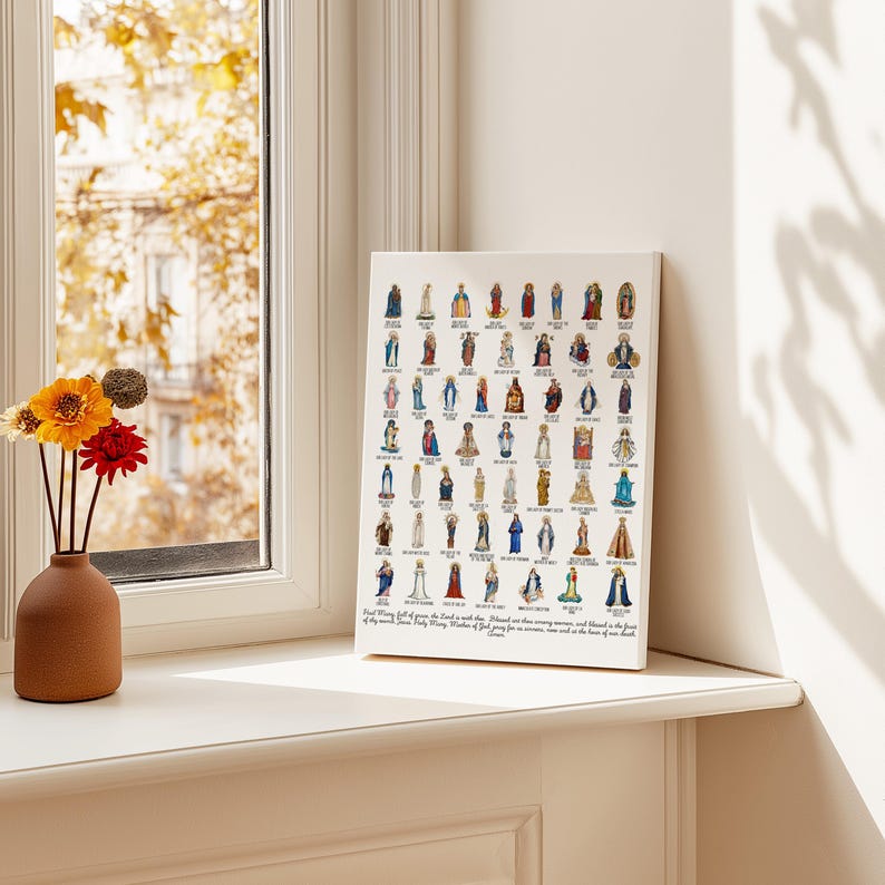 May include: A framed print featuring numerous illustrations of religious figures, displayed on a windowsill. The artwork is predominantly white with colorful depictions of saints and religious figures. A vase of flowers sits nearby.