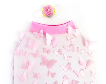 May include: A white dog shirt with a pink collar and pink butterfly appliques. The shirt has the text "Icecreamtree Studio" printed on the bottom.