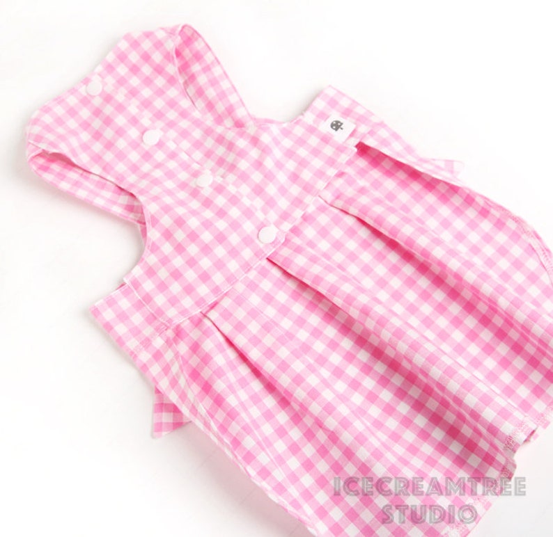 Puede incluir: Vestido de perro de cuadros vichy rosa y blanco con cierre de bot&oacute;n y un lazo en la espalda. El vestido est&aacute; hecho de una tela suave y c&oacute;moda y es perfecto para el uso diario.