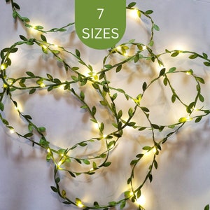 Delicate green leaf fairy lights with warm white LEDs on a white background