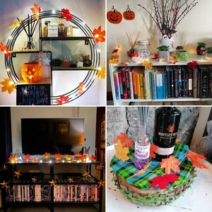 May include: A Halloween-themed home decor scene with a variety of fall foliage, pumpkins, and string lights. The scene includes a shelf with a pumpkin, a sign that says "Happy Pumpkin Season", and a variety of fall leaves. There is also a bookshelf with a variety of books, and a table with a bottle of liquor, a diffuser, and a variety of fall leaves.