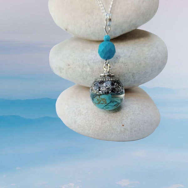 Turquoise sphere-shaped orgonite pendant made with turquoise, aluminum shavings and 925 sterling silver-plated chain.