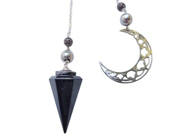 Hexagonal orgonite pendulum in black and silver tones, with a crescent moon and a semiprecious stone called: Shungite.