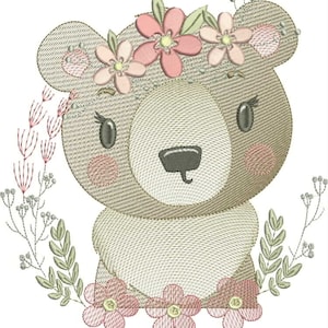 Pode incluir: Design bordado de um urso de pelúcia com uma coroa de flores e uma borda floral. O urso é marrom claro com detalhes em rosa. As flores são rosa e verde, criando uma estética suave e caprichosa. Ideal para artigos infantis.