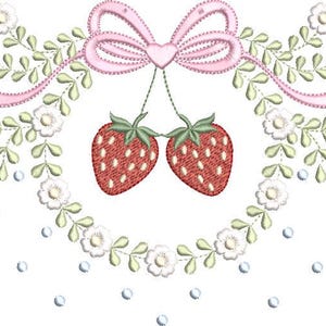 May include: An embroidered design featuring a pink bow with a heart, two hanging strawberries, and a wreath of white flowers and green leaves. Small red strawberries and light blue dots complete the design.