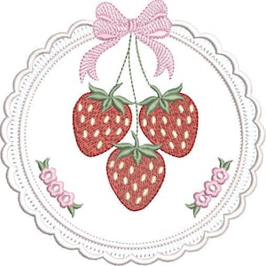 May include: Embroidered design featuring three red strawberries with green stems and white seeds, suspended from a pink bow. The strawberries are within a white, scalloped-edged circle, with pink floral accents.
