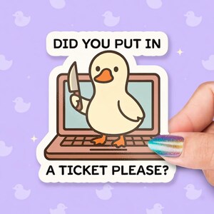 May include: A die-cut sticker featuring a light yellow duck with an orange beak standing on a brown laptop keyboard. The duck holds a silver knife in its wing. Above and below the laptop, the text reads: DID YOU PUT IN A TICKET PLEASE?