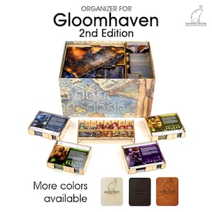 May include: A wooden organizer for the Gloomhaven 2nd Edition board game. The organizer has multiple compartments for game components. Text at the top reads "Organizer for Gloomhaven 2nd Edition". More colours are available.