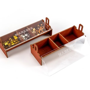 May include: A wooden box with a clear lid, divided into three compartments. The box is labelled "MARKERS" and contains small, colourful cubes.