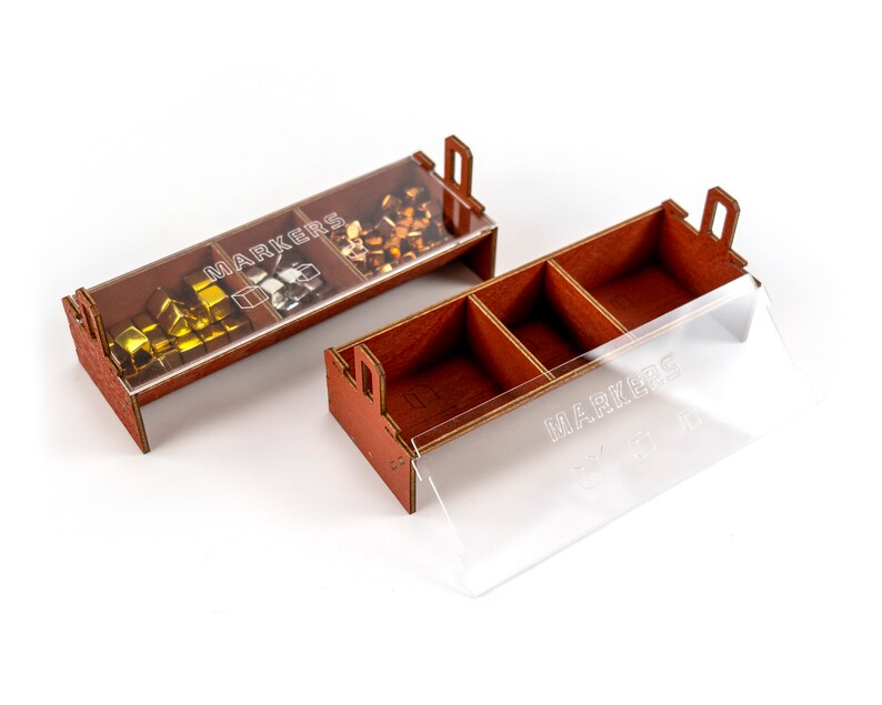 May include: A wooden box with a clear lid, divided into three compartments. The box is labelled "MARKERS" and contains small, colourful cubes.