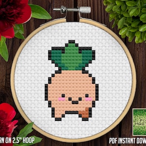 May include: A cross-stitch pattern of a cute pineapple with a green top and a peach-coloured body. The pineapple has a happy face with pink cheeks. The pattern is displayed in a 2.5 inch hoop. The text "PATTERN ON 2.5" HOOP" is at the bottom of the image. The text "PDF INSTANT DOWNLOAD" is at the bottom right of the image. The text "PIXEL MASTERS" is in a green pixelated font at the bottom right of the image.