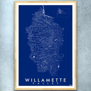 May include: A blue and white map of the Willamette Valley in Oregon. The map shows the rivers and streams in the valley. The map is framed in a light wood frame.