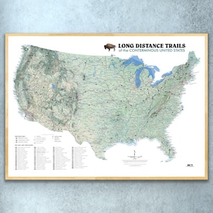 May include: A map of the contiguous United States showing long distance trails. The map is printed on white paper and framed in a light wood frame. The title of the map is "Long Distance Trails of the Conterminous United States".