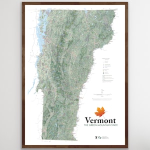 May include: A framed map of Vermont, showcasing the state's topography in shades of green and brown. The map includes roads, waterways, and other geographical features. The state's name and the phrase "The Green Mountain State" are displayed with a maple leaf.