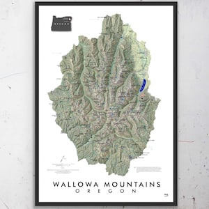 May include: A detailed map of the Wallowa Mountains in Oregon. The map shows the location of various lakes, rivers, and trails. The map is printed on white paper and framed in a black frame.