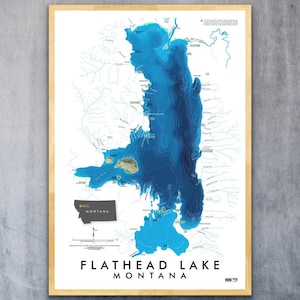 May include: A framed bathymetric map of Flathead Lake in Montana, featuring varying shades of blue to indicate water depth. The print includes a small inset map of Montana, detailed shoreline topography, and the text Flathead Lake Montana.
