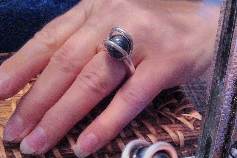 A gorgeous 12 mm hematite sphere with an 8 gauge thick band in fine silver size 6 and 12