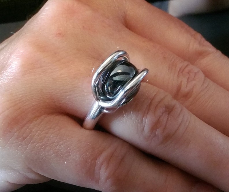 A gorgeous 12 mm hematite sphere with an 8 gauge thick band in fine silver size 6 and 12