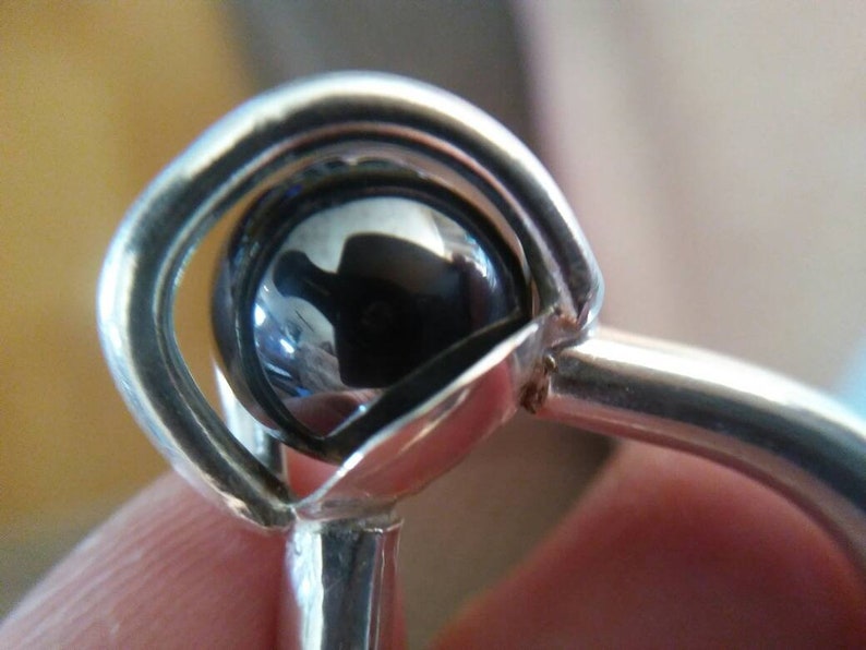 A gorgeous 12 mm hematite sphere with an 8 gauge thick band in fine silver size 6 and 12