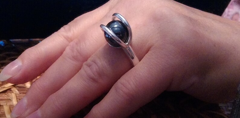 A gorgeous 12 mm hematite sphere with an 8 gauge thick band in fine silver size 6 and 12