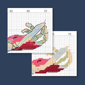 May include: Two cross-stitch patterns are displayed against a dark blue background. The patterns feature a crab design with red, pink, beige, and gray sections. The patterns are on a grid, with numbers along the edges.
