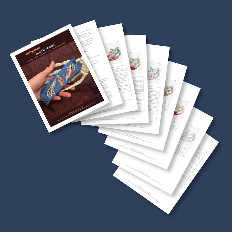 May include: A stack of white paper sheets with a blue bookmark and a hand holding it. The bookmark has a blue background with colorful embroidered designs. The top sheet reads "methysphere Hand Bookmark". The background is a dark maroon color.