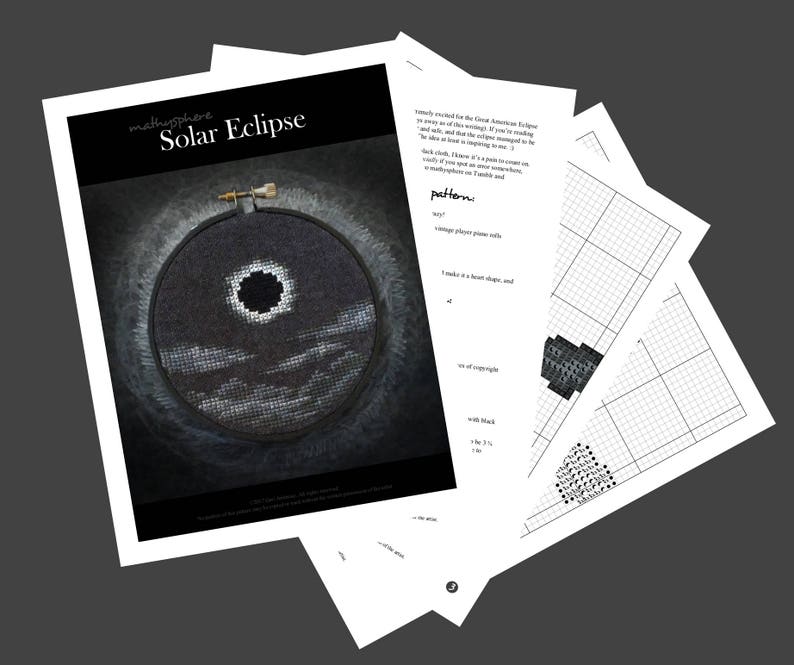 May include: A black and white cross-stitch pattern of a solar eclipse with the sun and moon in the center, surrounded by clouds. The pattern is printed on a white sheet of paper with a grid.
