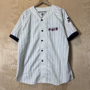 May include: White baseball jersey with black pinstripes, black buttons, and black sleeves. The jersey features the text "Magic" in purple and blue, and the Starter logo on the sleeve.