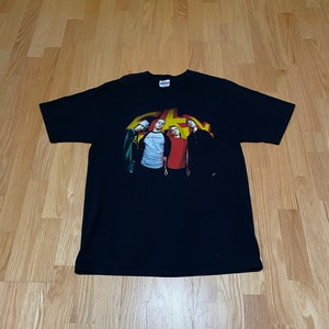 May include: Black t-shirt with a graphic of a band called "Saves the Day" with four members in front of a yellow and red background.