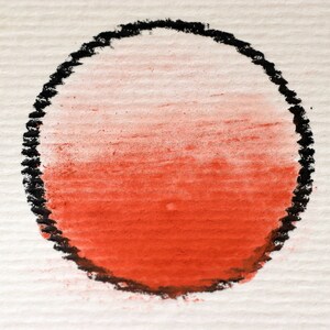 May include: A red and white ombre circle drawn in black chalk on a white textured surface.