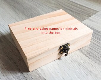May include: A light wood box with a black latch. The box has the text "Free engraving name/text/initials into the box" written on the top.