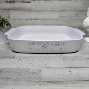 May include: A set of three ceramic mugs with a speckled, matte finish. The mugs are in shades of cream, light gray, and dark gray. Each mug has a simple, minimalist design and a rounded handle.