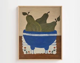May include: A framed painting shows three green pears in a blue bowl with white stripes. The bowl rests on a white doily with red floral accents. The background is a light tan colour.