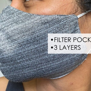 May include: Gray face mask with a filter pocket and three layers. The mask is made of a soft, breathable fabric.