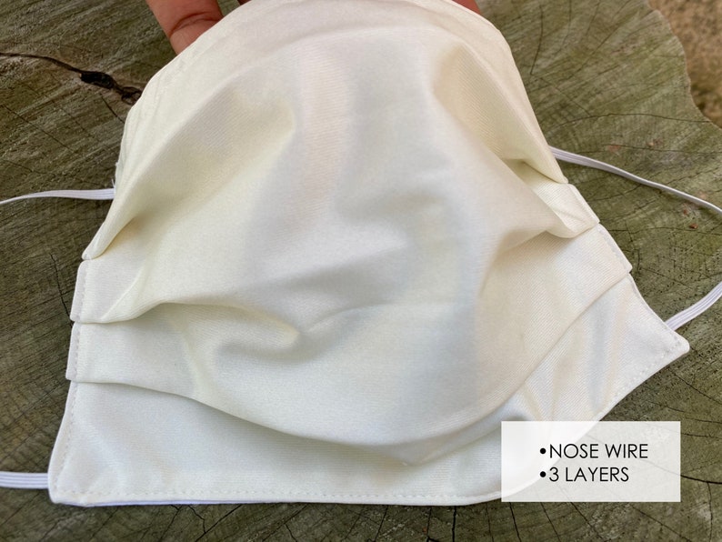 Pu&ograve; includere: Una maschera facciale bianca a tre strati e un filo per il naso. La maschera &egrave; realizzata in un tessuto morbido e liscio.