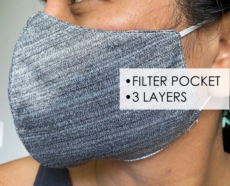 May include: Gray face mask with a filter pocket and three layers. The mask is made of a soft, breathable fabric.