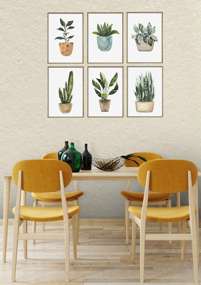 May include: Six framed watercolor illustrations of potted plants, displayed on a wall above a wooden dining table with four yellow chairs.