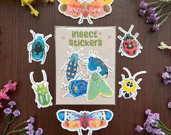 May include: A clear plastic sleeve containing multiple insect stickers with the text insect stickers printed on the front. Surrounding the sleeve are individual stickers of various beetles and moths in vibrant colors like blue, green, yellow, and red.
