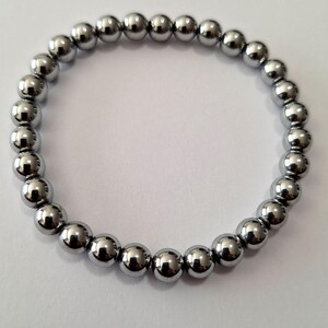 May include: A silver beaded bracelet with round beads.