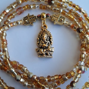 May include: Gold beaded necklace with a gold Ganesha pendant and two gold hamsa charms.