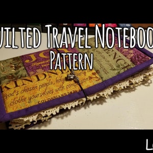 May include: A quilted travel notebook with a purple fabric cover and a lace trim. The cover is decorated with a patchwork of fabric squares featuring inspirational quotes and designs. The notebook is closed with a purple ribbon and a metal charm.